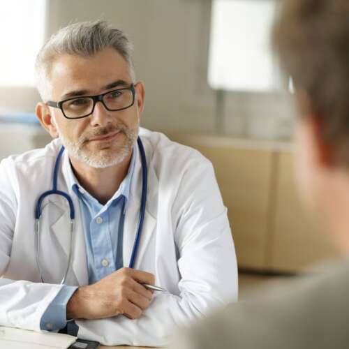 stock-photo-doctor-talking-to-patient-in-office-741584056-transformed